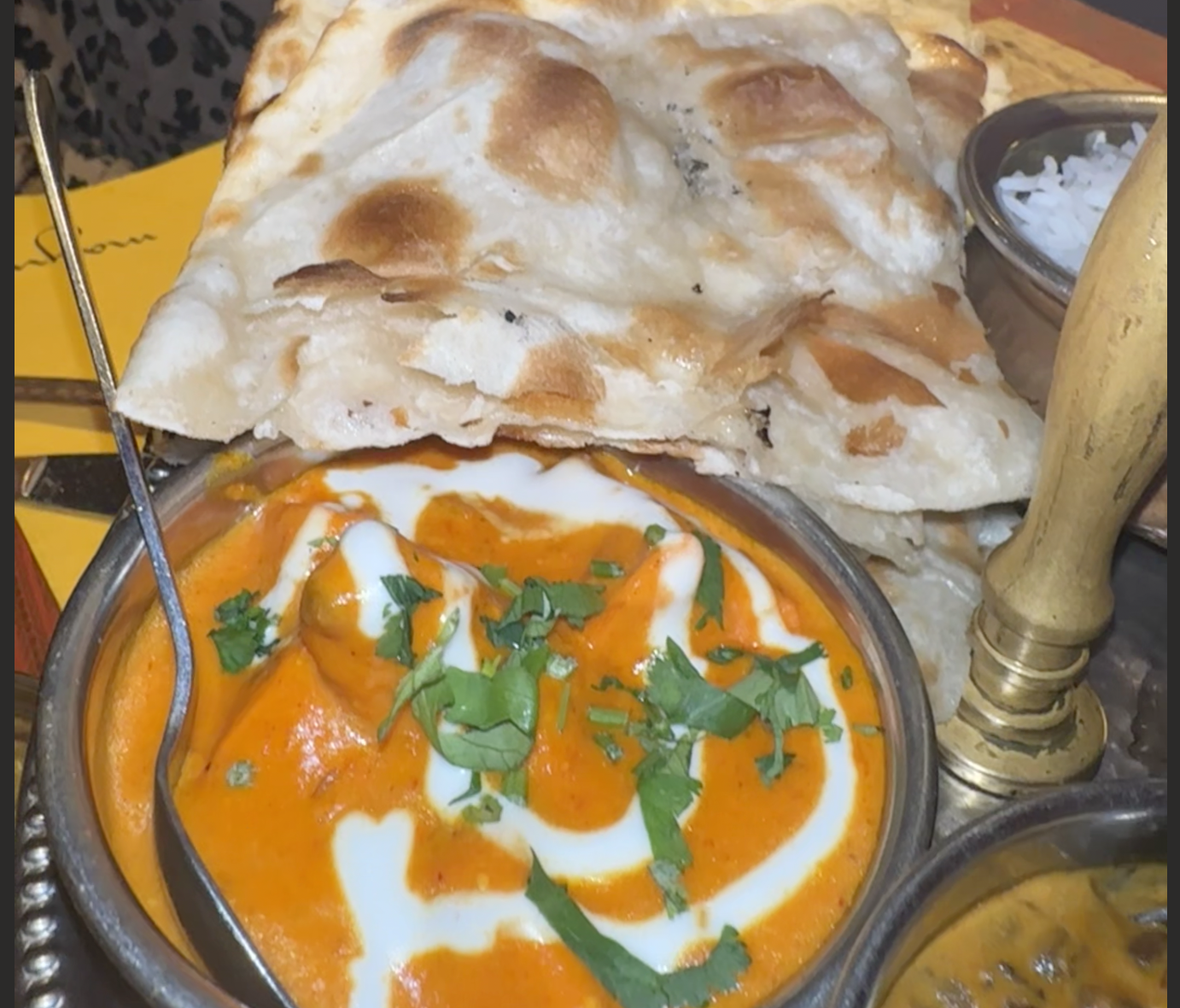 A pot of curry chicken with Naan bread